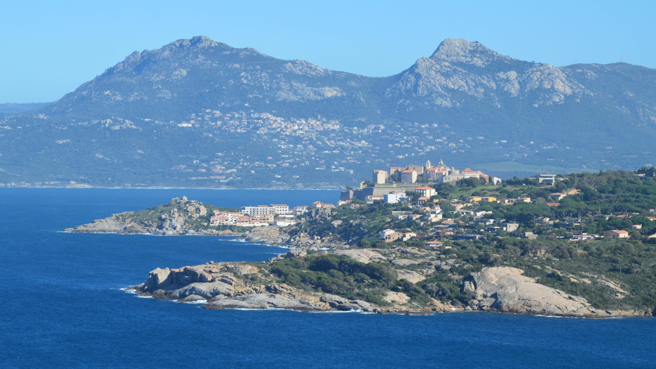Stunning view of Calvi coastline with mountains and Mediterranean Sea in Corse, France.